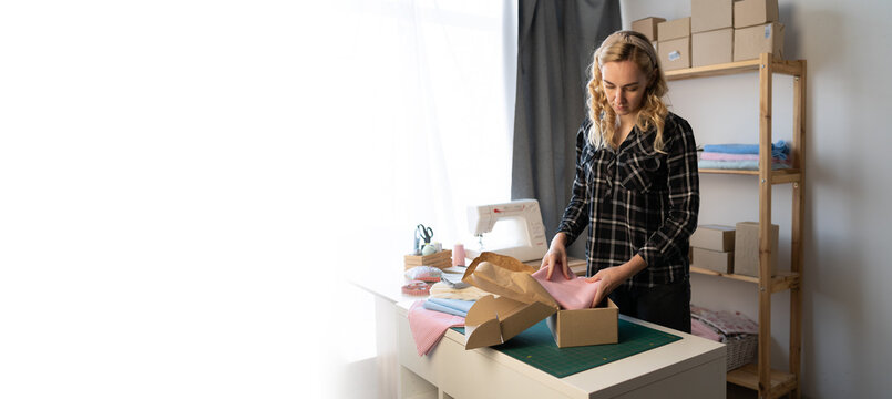 Startup small business entrepreneur SME, woman packing box. young seamstress small business owner in home office, online sell delivery, SME e-commerce concept