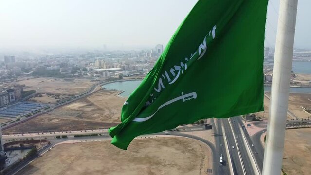 Aerial view of the Saudi Arabia National Flag waving on a pole in Jeddah