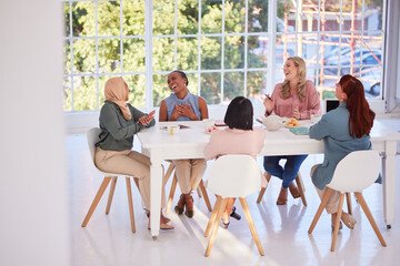 Collaboration, food and team building with a business woman group sitting around a table for...
