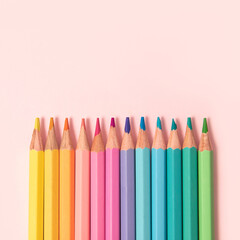 Pastel colored pencils on pink background