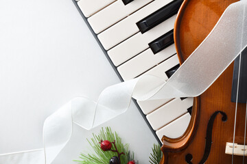 Detail christmas musical event with piano and violin on white