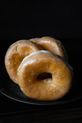 Delicious sugar donuts on a dark background