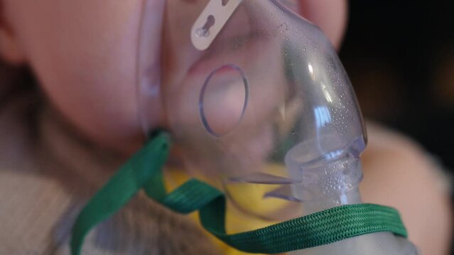 Close up of steam inhalation for an infant newborn baby, breathing through mask