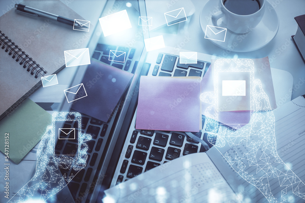 Poster Envelop hologram drawing over computer on the desktop background. Top view. Double exposure. Technology concept.
