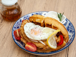 Waffle sandwich with fried chicken and egg