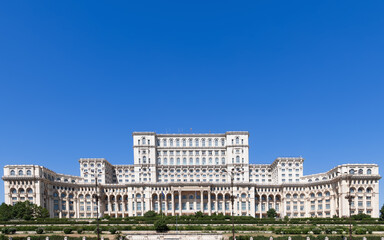 Fototapeta na wymiar Widescreen view of the Palace of the Parliament (Romanian: Palatul Parlamentului) is the seat of the Parliament of Romania in Bucharest