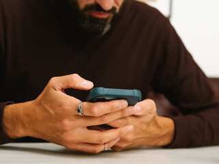Businessman using his phone in the Cofee Shop.
