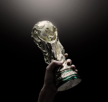 Bangkok Thailand. July 15 2018. Mock Up of the FIFA World Cup Trophy in  hand and Black Background. Man holding a trophy of the FIFA World Cup in  hand. Fifa 2022 winning