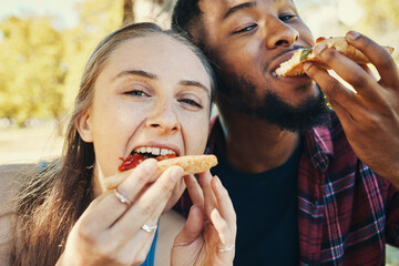 Pizza, love and happy couple eating fast food while on a date together in nature in a garden....