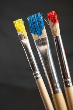Artist paint brushes with yellow, red, blue colors
