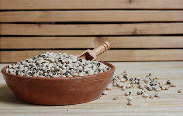 Uncooked Black Eyed Peas in Bowl on Wooden Table