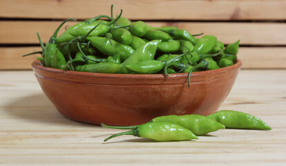 Bowl of Fresh Green Aji Limo Chili Peppers on Wooden Table