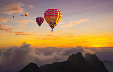 Colorful hot air balloons flying over mountain at Doi Luang Chiang Dao at sunset time in Chiang Mai, Thailand.