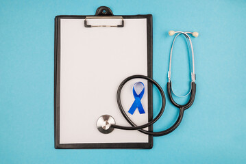  stethoscope clipboard with sheet of paper and blue silk ribbon prostate cancer awareness symbol on isolated