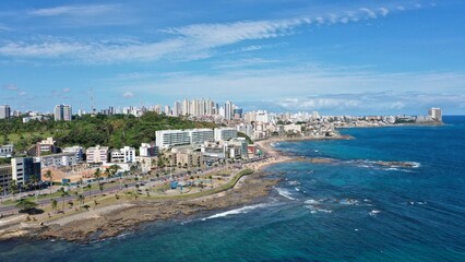 Fototapeta na wymiar Panoramic view of a beautiful white sand beach with turquoise waters of the Atlantic Ocean in Salvador, capital of Bahia State, Brazil 