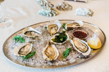 Fresh raw opened oysters with ice and lemon