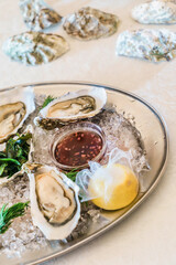 Fresh raw opened oysters with ice and lemon
