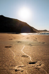 Footsteps in the sand in a beautiful sanset