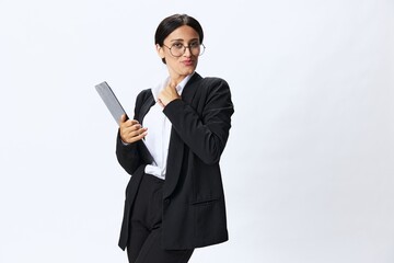 Obraz na płótnie Canvas Business woman with a folder of documents in her hands in a black business suit and glasses shows signals gestures and emotions on a white background, work freelancer online training