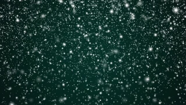 Winter holidays and wintertime background, white snow falling on festive green backdrop, snowflakes bokeh and snowfall particles as abstract snowing scene for Christmas and snowy holiday design. High