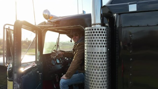 Professional Semi Truck Driver Behind the Wheel. American Transportation Industry Theme.