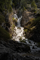 Lights and shadows on the famous waterfalls of Madonna di Campiglio, in the Italian Dolomites