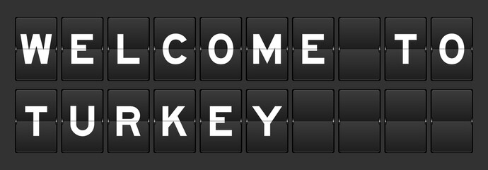 Black color analog flip board with word welcome to turkey on gray background