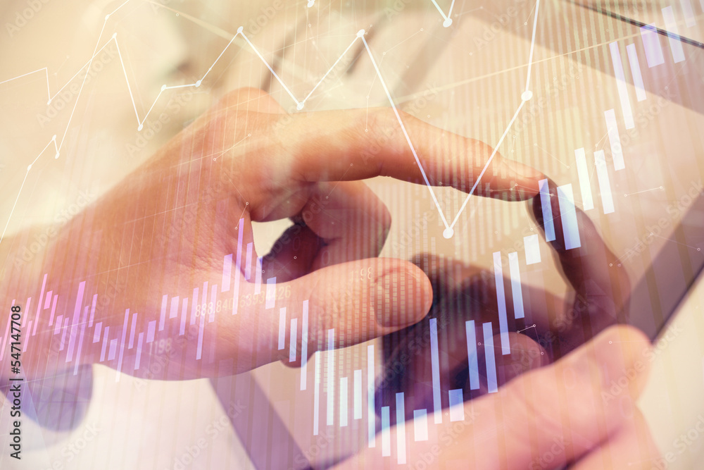 Poster multi exposure of man's hands holding and using a phone and financial chart drawing. market analysis