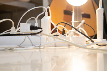 Electric extension cords with a switch. Many chargers are on. Selective focus. Concept.
