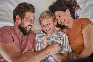 Top view, parents or boy bonding in tickle game on house, family home or hotel bed in trust, love or security. Smile, happy man or laughing woman and son, comic child or preteen kid in funny activity - obrazy, fototapety, plakaty