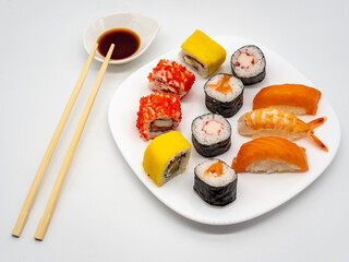 sushi on a plate with chopsticks