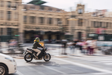 Obraz na płótnie Canvas Man driving a scooter in the city