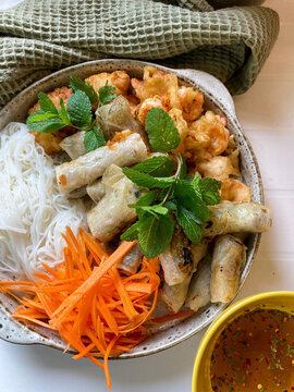 Homemade bobun. Vietnamese noodles with spring rolls and shrimp