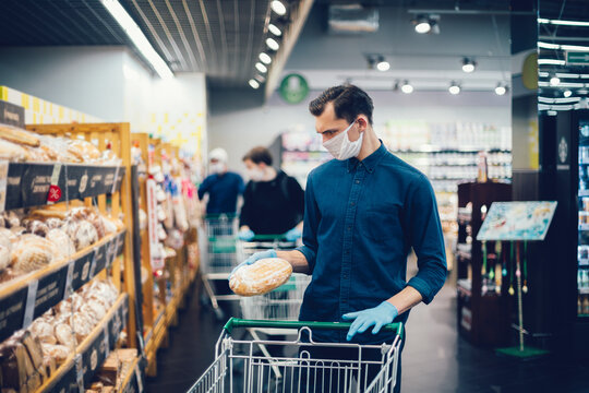 Close Up. Young Man Buying Bread In A Supermarket.