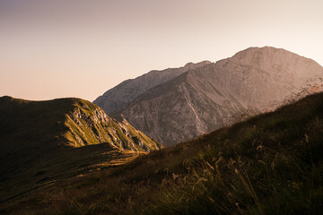 Warm sunset light shines on the rocky cliffs of the Orobie Alps, Northern Italy