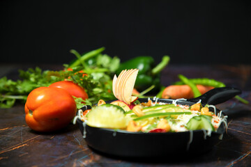Vegetarian restaurant dishes top view, hot spicy indian soups, rice and salads in bowls. Traditional indian cuisine meal assortment on wood background