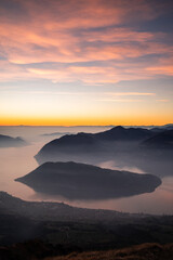 Beatiful pink clouds during sunset at Punta Almana, with the famous Montisola in the background, Northern Italy