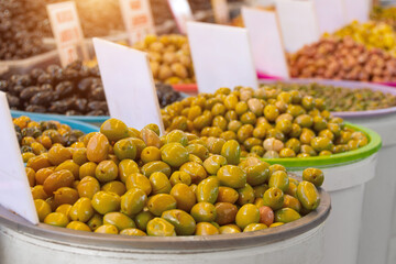 Olives marinated in containers on the sale of the market.