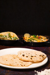Indian Traditional Cuisine Chapati or Roti, or Indian Bread in white plate with flour