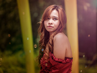 Young beautiful model posing for the camera surrounded by bubbles