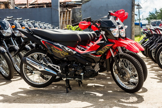 Bohol, Philippines - Oct 2022: Rows of Honda XRM 125 motorcycles for sale at a dealership. Motorbikes at an outdoor lot.