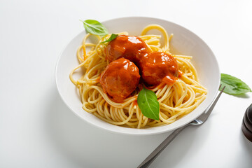 Pasta spaghetti with meatball red sauce on light surface