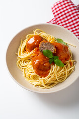 Spaghetti with meatball red tomato sauce in bowl on light surface italian food