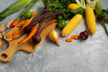 Cooking food concept carrots beer top view sweet corn fresh vegetables cutting board space for text