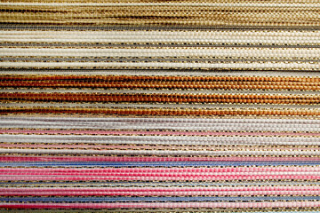 Woven texture multicolored background. Seamless fabric background