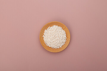 Potassium sorbate, granular potassium salt of sorbic acid in wooden plate, top view. Food additive...
