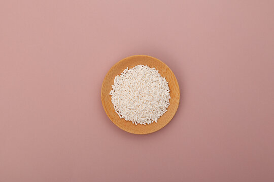 Potassium sorbate, granular potassium salt of sorbic acid in wooden plate, top view. Food additive E202 used in variety of applications including food, wine, and personal-care products