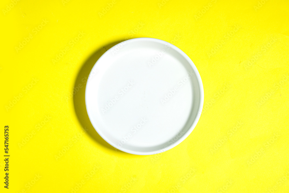 Sticker Modern oriental ceramic plate View from above isolated on yellow background with clipping path