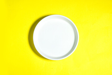 Modern oriental ceramic plate View from above isolated on yellow background with clipping path