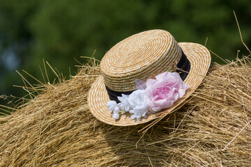 Close-up view of straw hat on hay bale in Provence